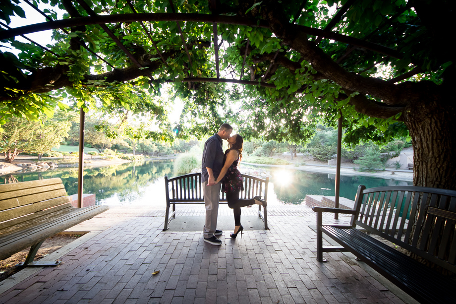 Dramatic and romantic engagement photo - kissing under a tree