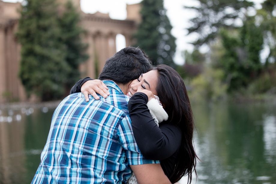 The couple hugging after a successful marriage proposal at the Palace of Fine Arts