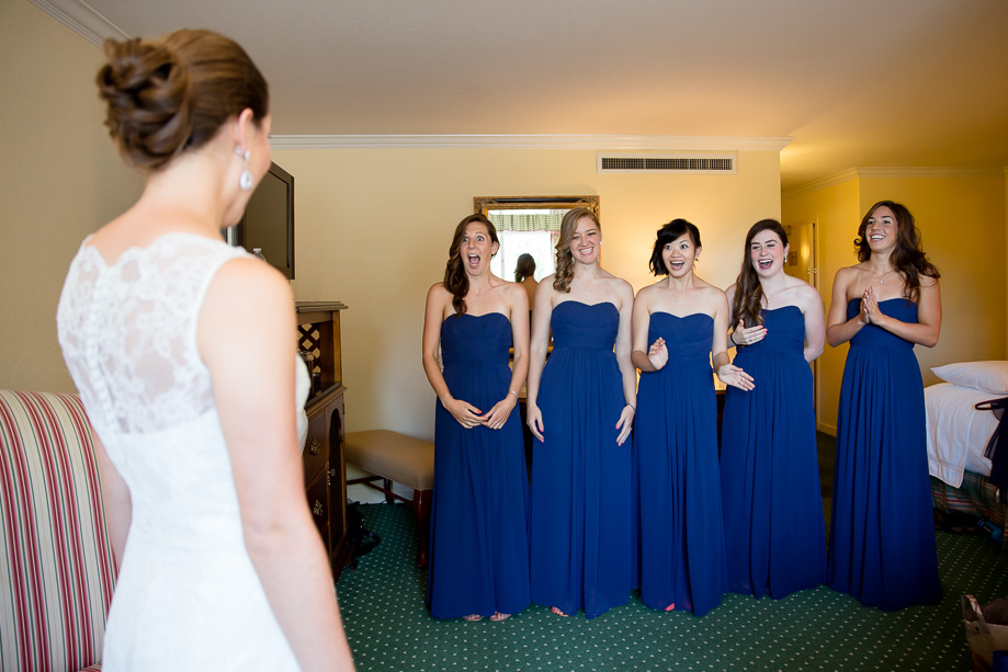 The bridesmaids first seeing the beautiful bride in her wedding dress