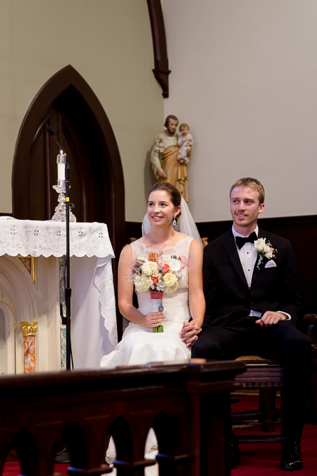 Bride and groom looking on as the pastor speaks