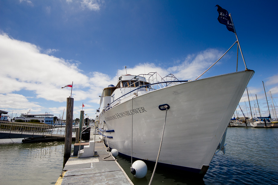 The Commodore Hornblower cruise ship docked at Berkeley Marina under a sunny blue sky