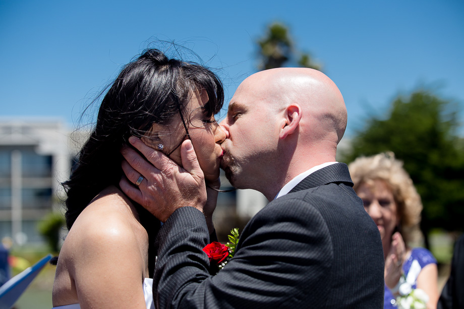 newlyweds kissing at the end of the ceremony just after the you may kiss the bride
