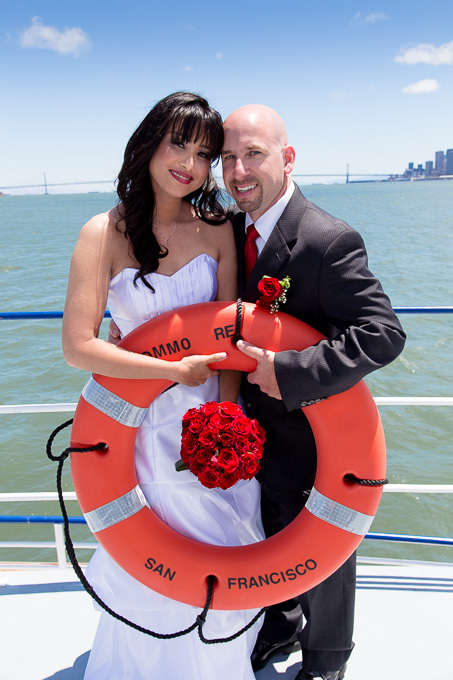 bride and groom holding a lifesaver from the Commodore Hornblower in the San Francisco Bay
