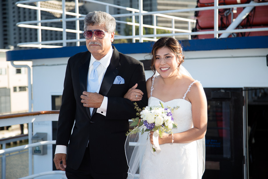 Father and bride walking down the aisle during wedding ceremony