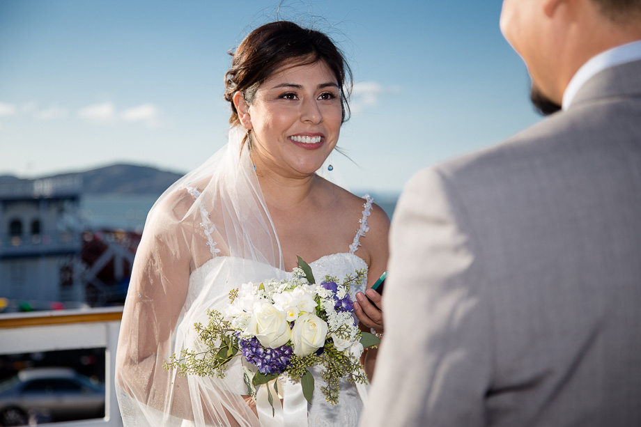Bride reciting her vows to the groom during their cruise wedding ceremony