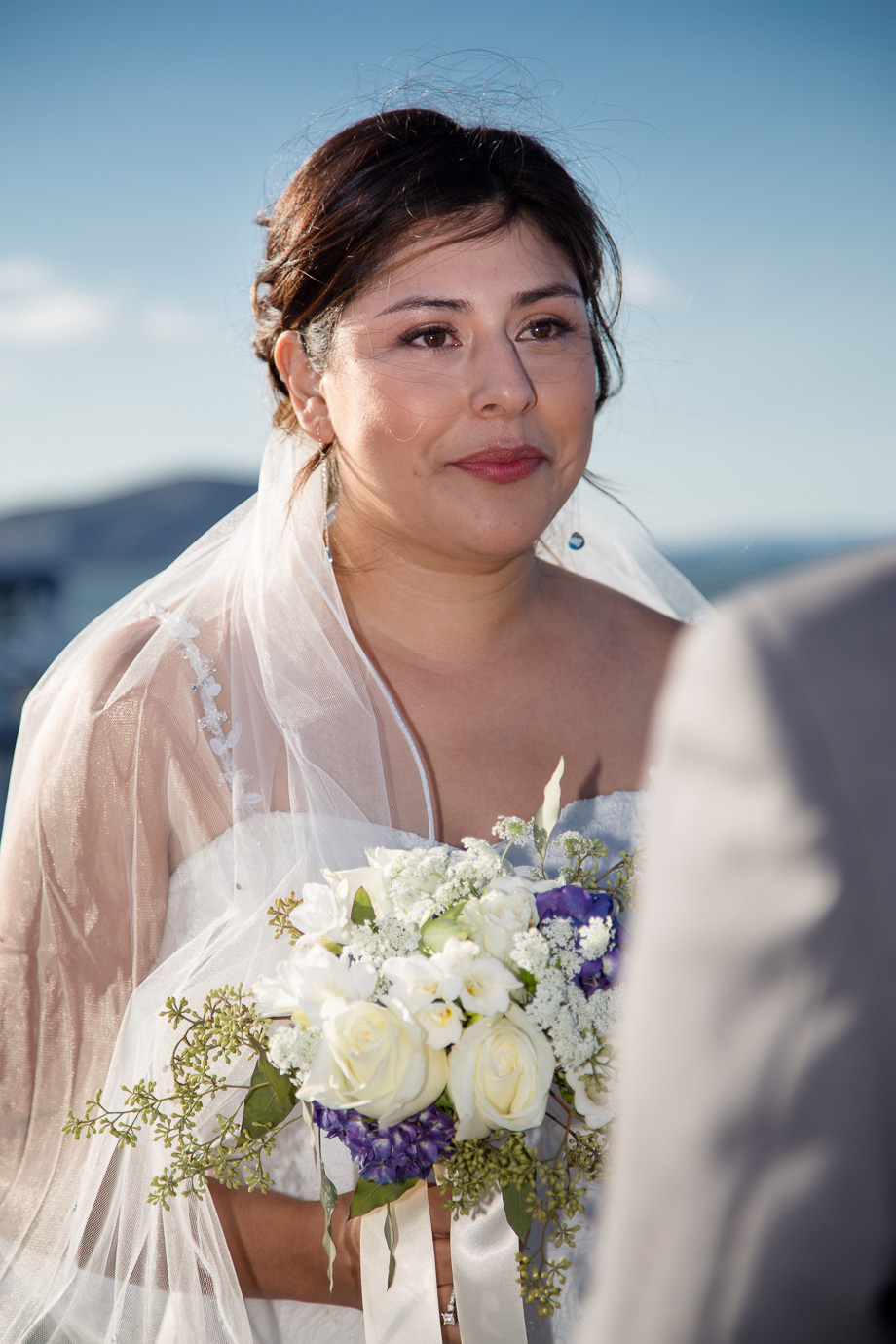 Teary-eyed bride looking at groom