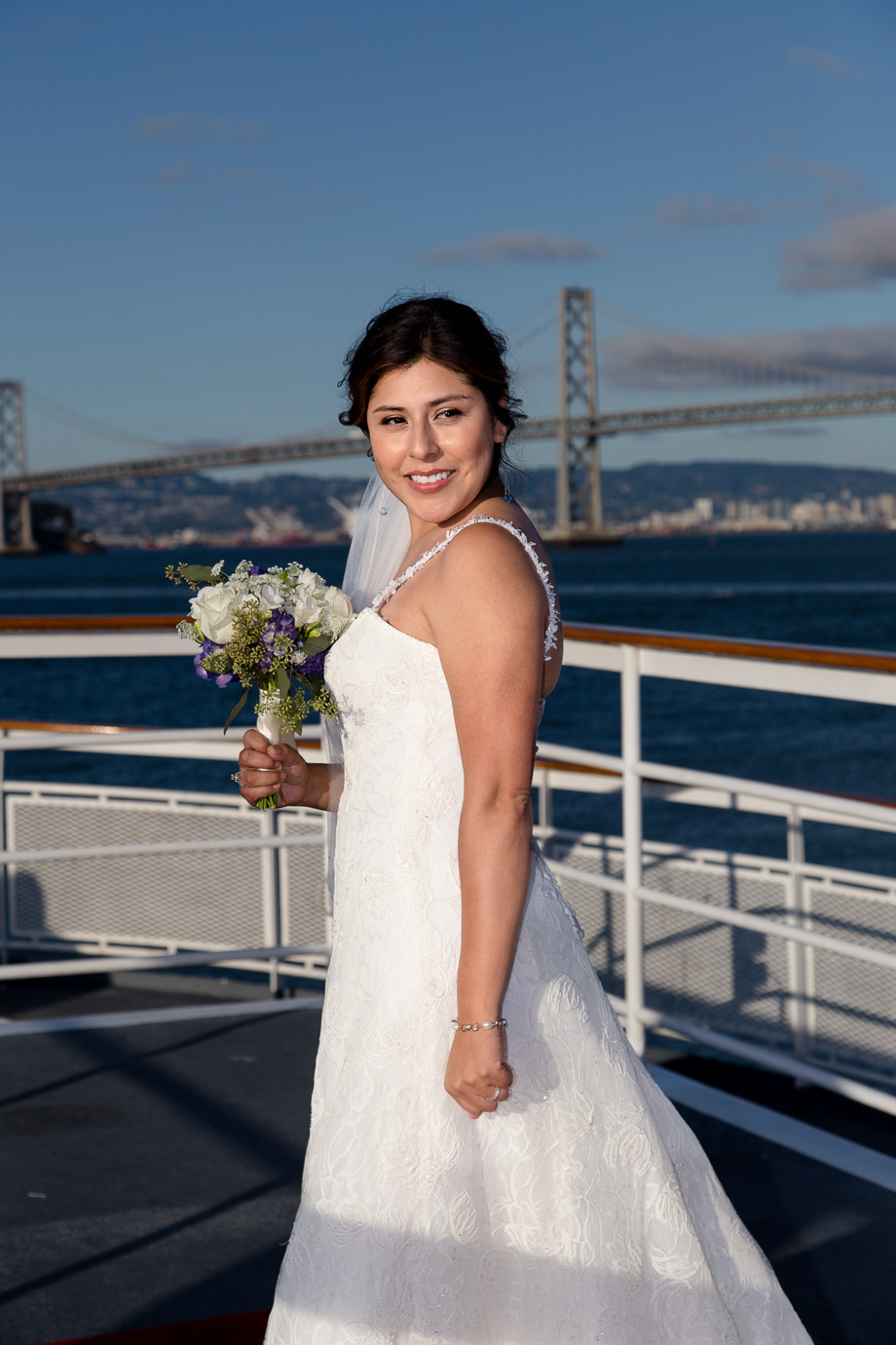 Portrait of the bride and her bouquet with the Bay Bridge in the background