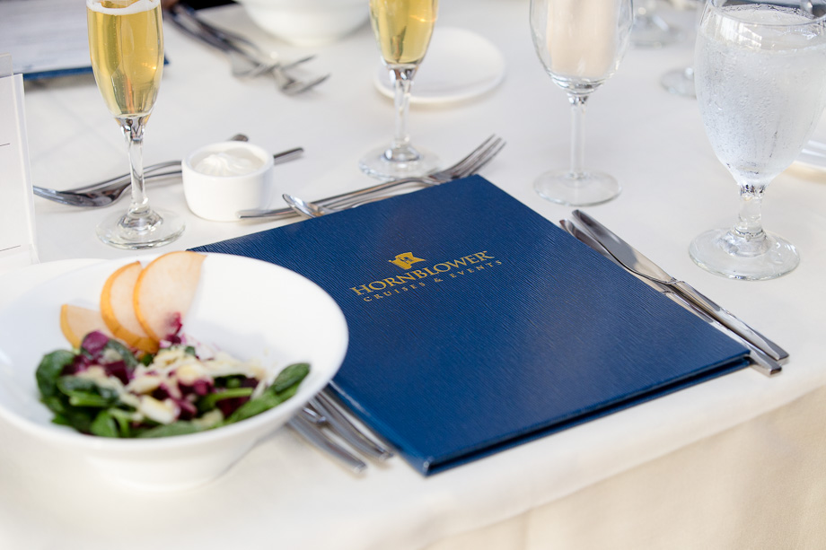 Hornblower Cruises & Events dinner menu with champagne glasses and salad