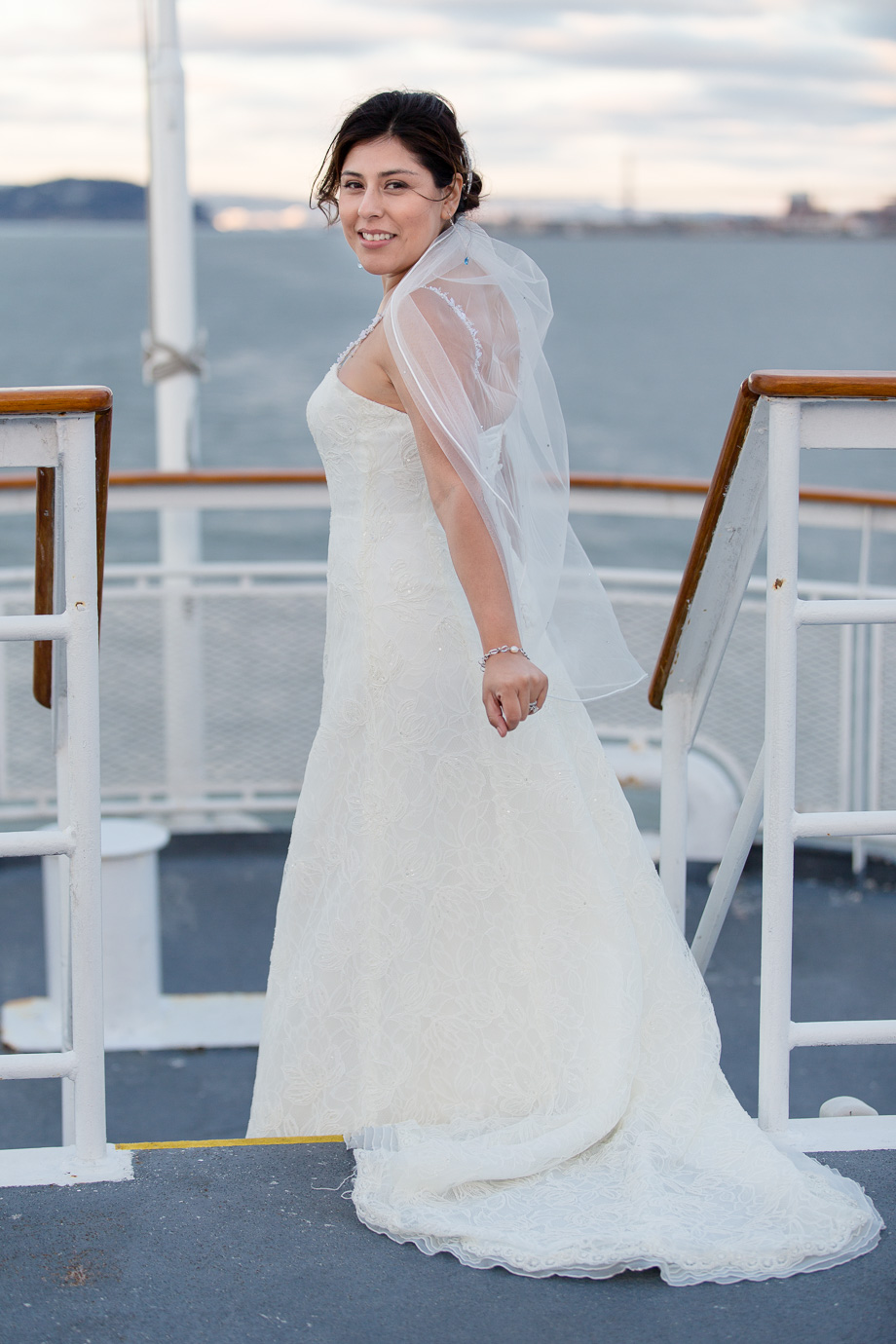 Bride on the top deck of the cruise ship looking back