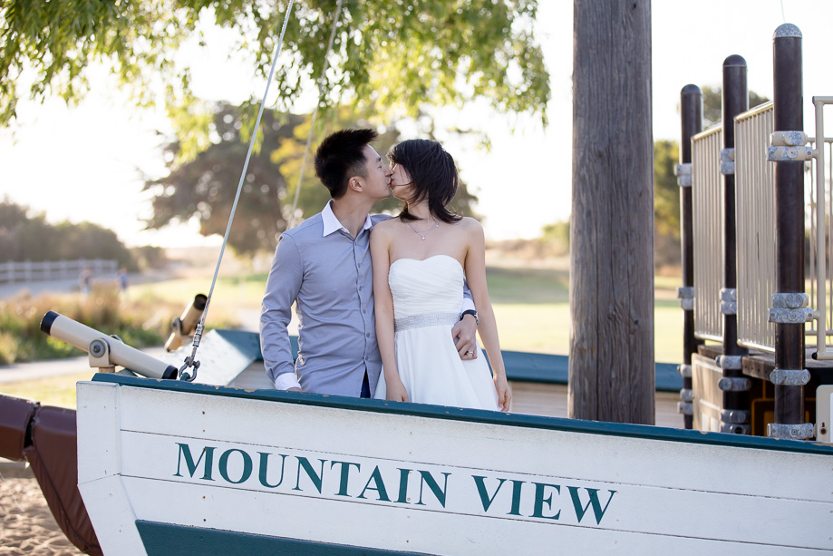 couple kissing on a Mountain View boat playground in a park