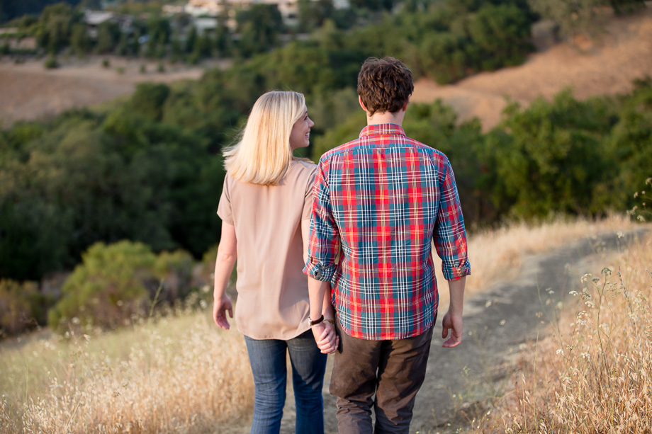 Newly engaged couple on romantic walk on a trail at Foothiils Park in Palo Alto