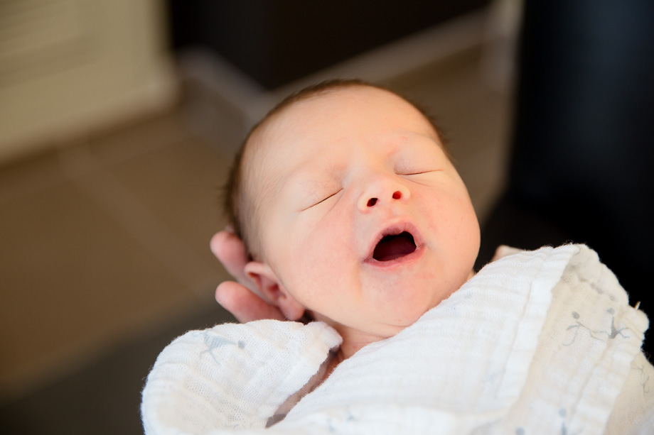 sleepy newborn baby yawning