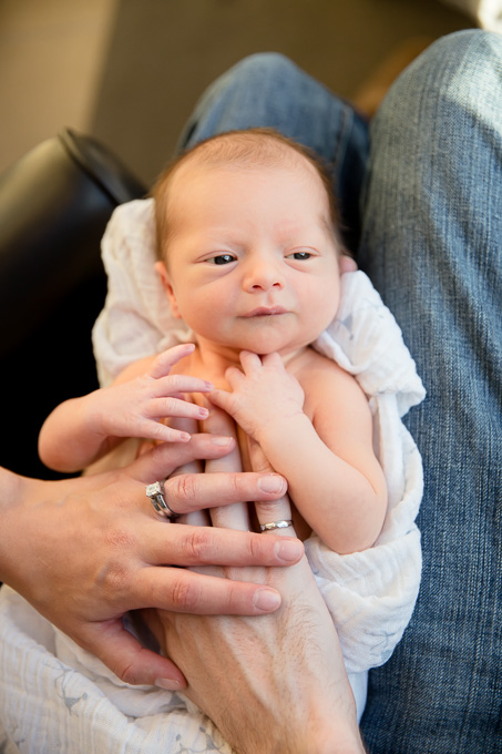 newborn baby on parents lap