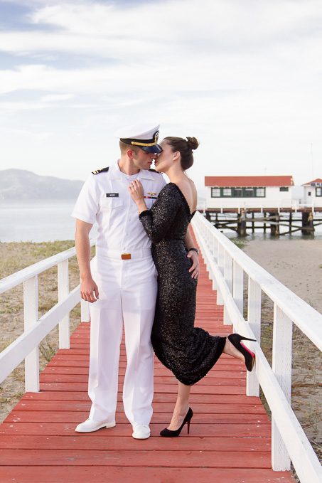 Engagement photo of couple about to kiss on a red boardwalk at Crissy Field