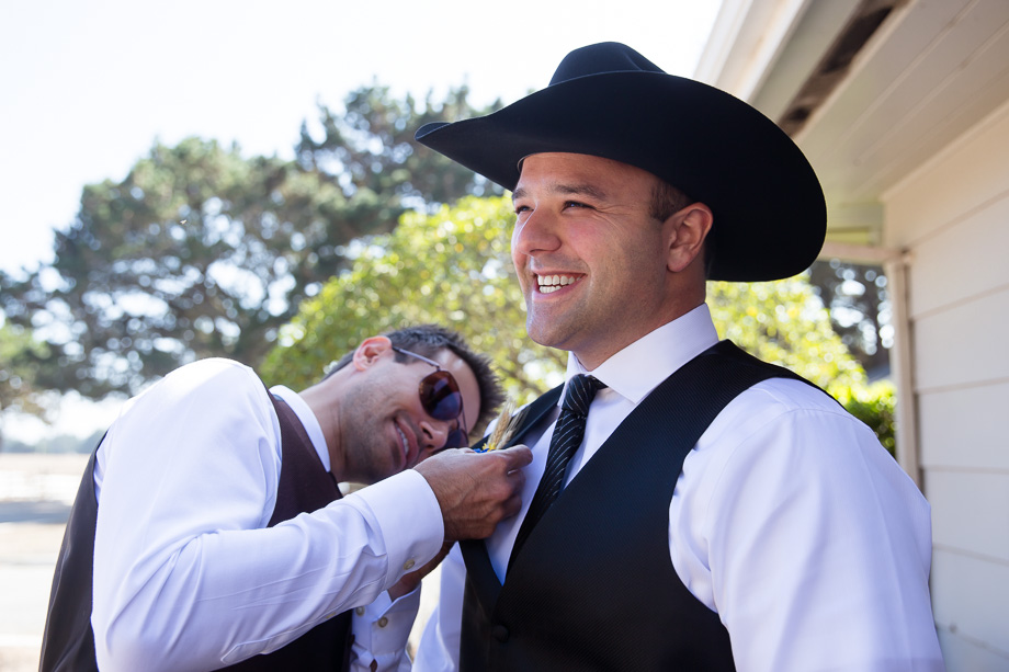 Best Man helping groom pin his boutonniere