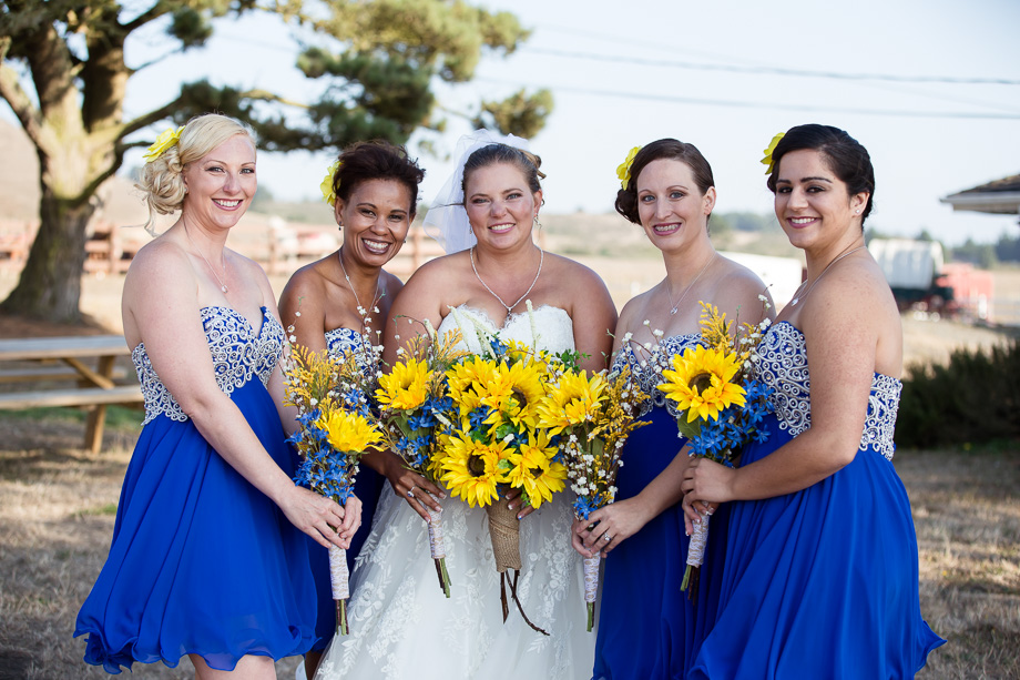Portrait of bride and bridesmaids holding their pretty yellow sunflower bouquets