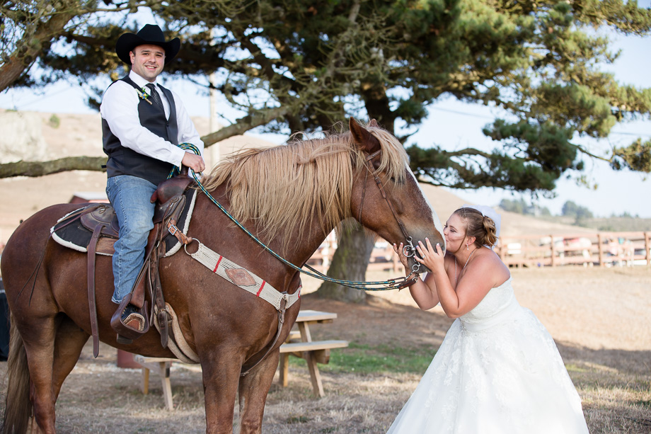 Bride kissing horse after their wedding ceremony in Bodega Bay
