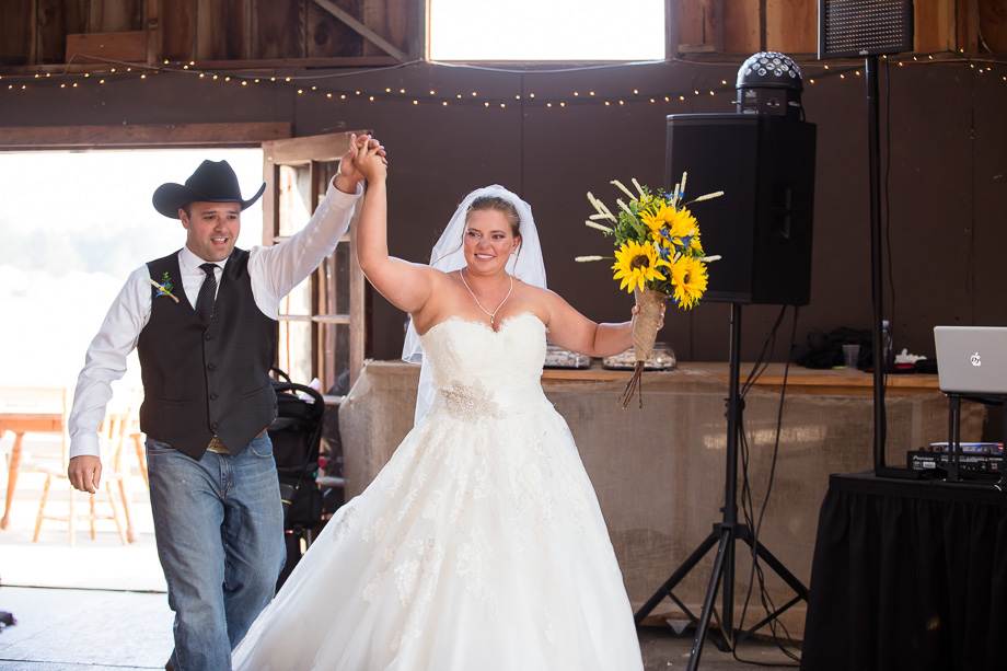 Bride and groom grand entrance into barn wedding reception