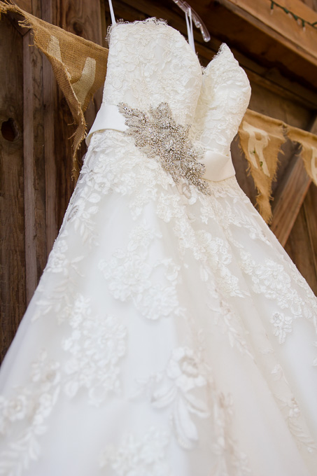 Wedding dress hanging up on barn door