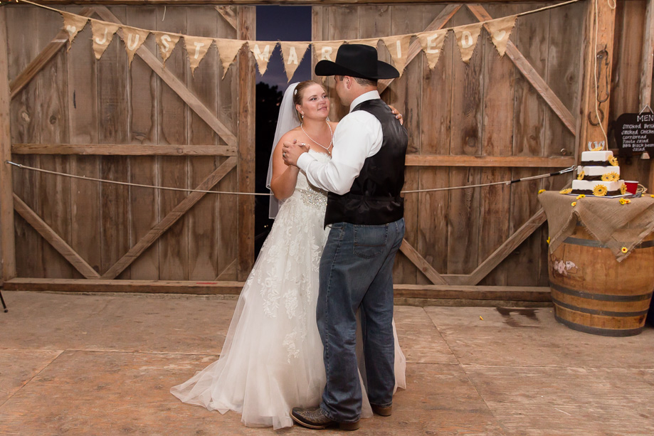 Bride and groom looking into each others eyes during first dance at Chanslor Ranch barn