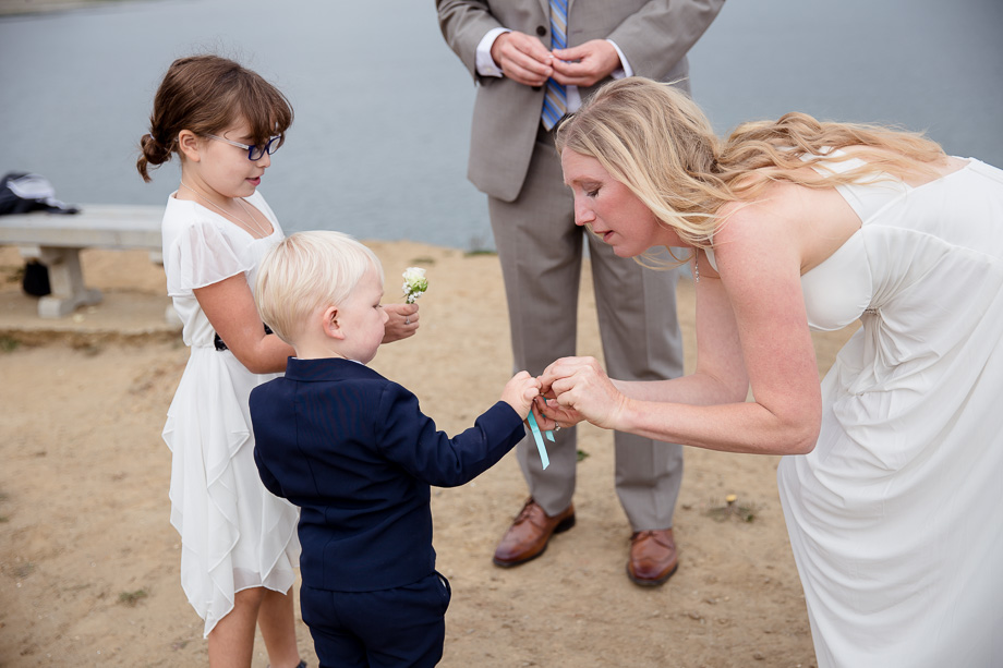 The adorable little ring bearer is careful fulfilling his duty