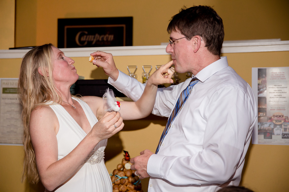 Bride and groom feeding each other cake at the Mezzaluna restaurant