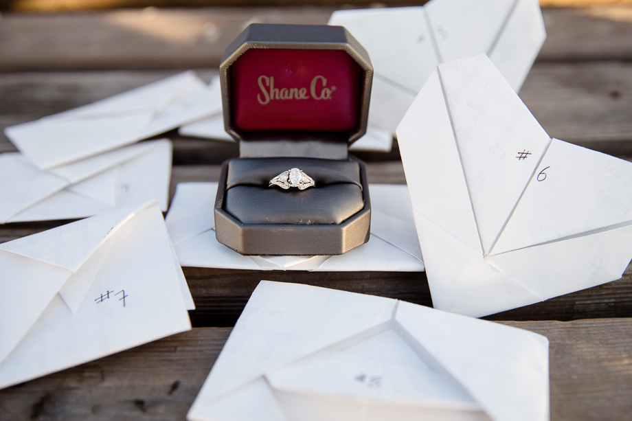 Shane Co engagement ring with folded scavenger hunt clues for the proposal