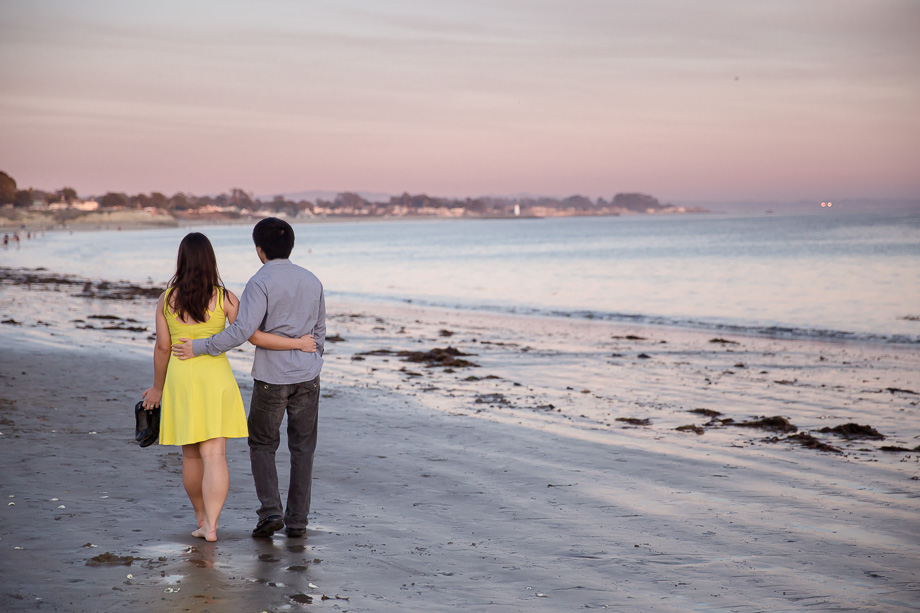 couple walking along the Santa Cruz beach near the boardwalk