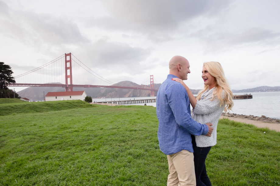 Bright and clean engagement photo for Katie and Alfred with Warming Hut Cafe and Golden Gate Bridge as the background