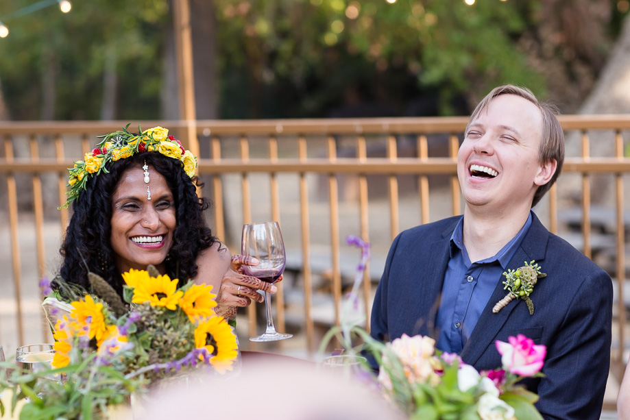 Kurt and Sumi laughing at a guests speech at the reception