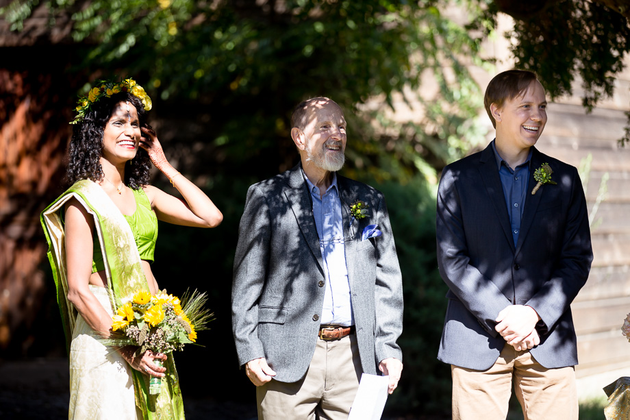 Bride, groom, and officiant looking at the audience