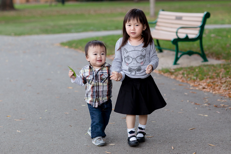 3 yr old big sister walking with 15 month little brother in the park