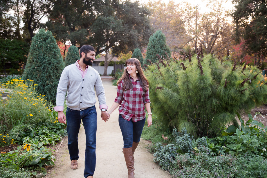 photo of couple walking down a pathway lined with flowers and bushes at Gamble Garden