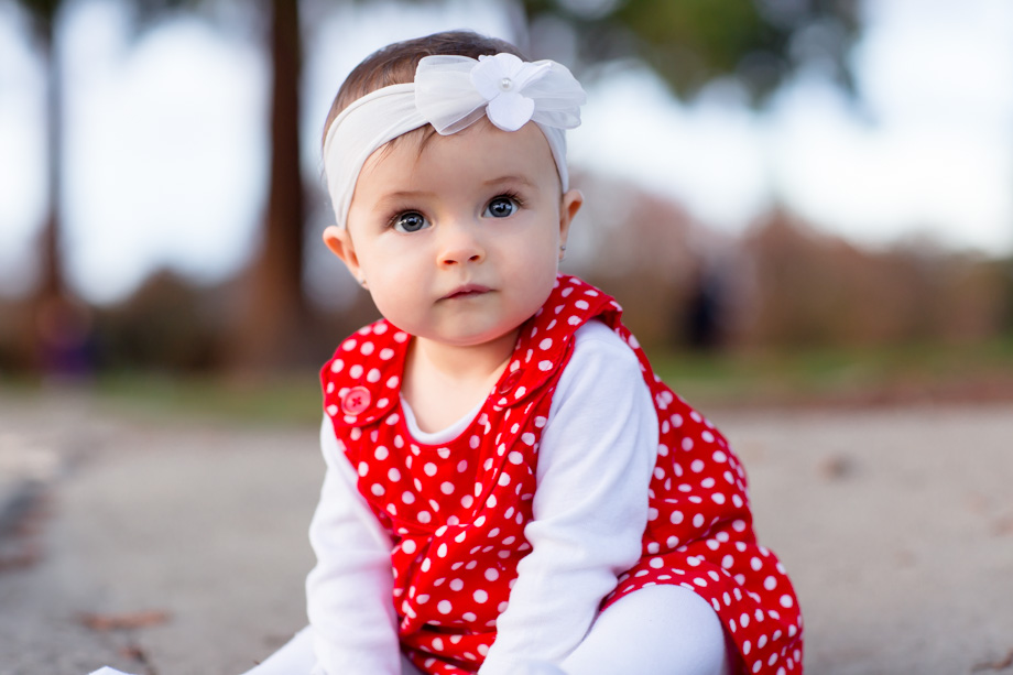 Pretty red polka dot dress and a white floral headband for the cute baby Christmas photo