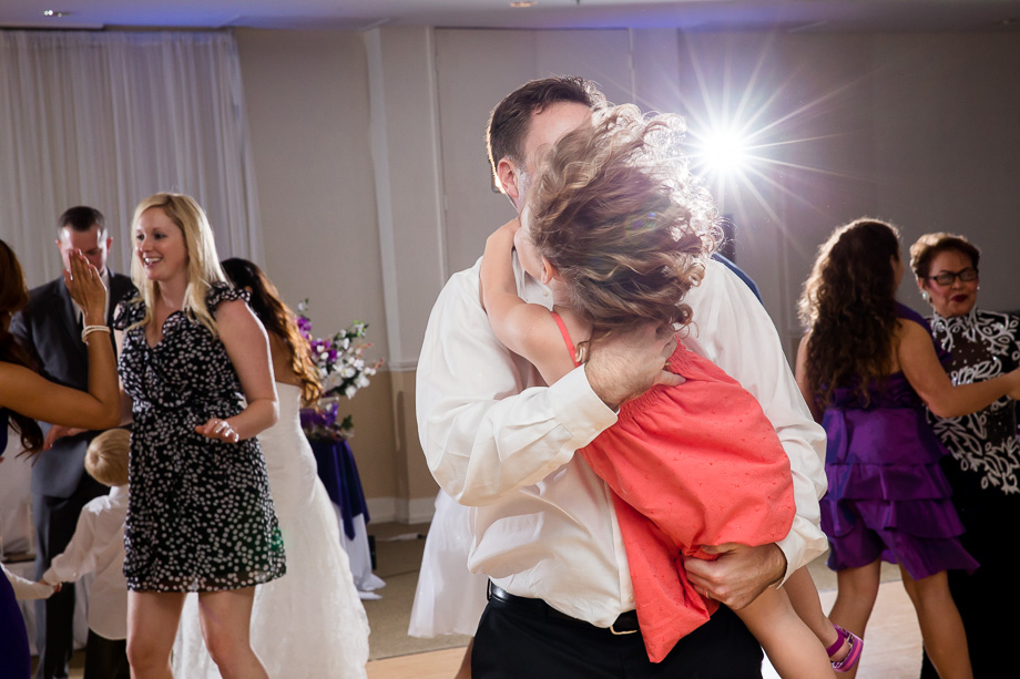 little girl being swung around by her dad while dancing at wedding at Boundary Oak Golf Club