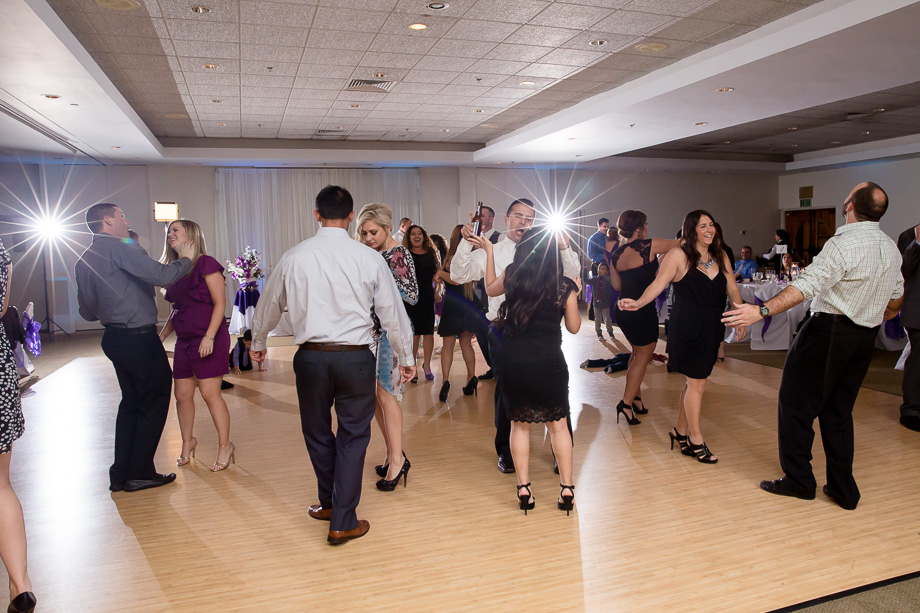 wedding guests packed on the dance floor in the reception ballroom dancing with each other at Boundary Oak Golf Club