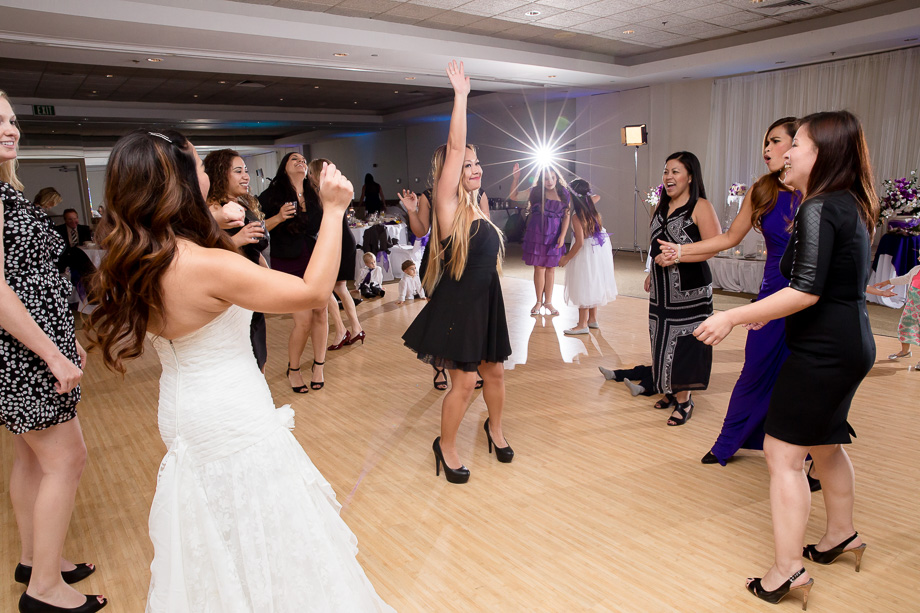 wedding guests in a circle dancing and having fun at Boundary Oak Golf Club
