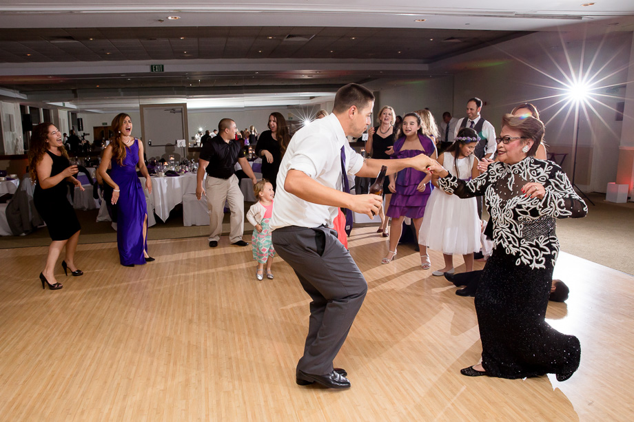 guests circled up around the dance floor dancing and laughing with each other at Boundary Oak Golf Club