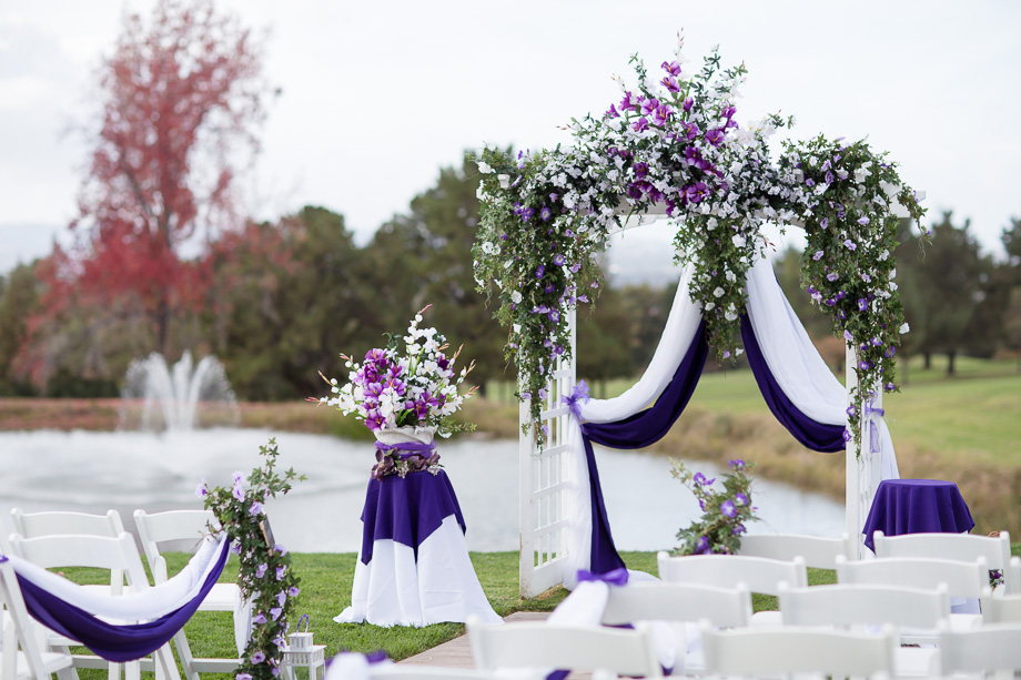 Gorgeous purple floral arrangement with lovely fountain at the back at the Boundary oak golf club ceremony site