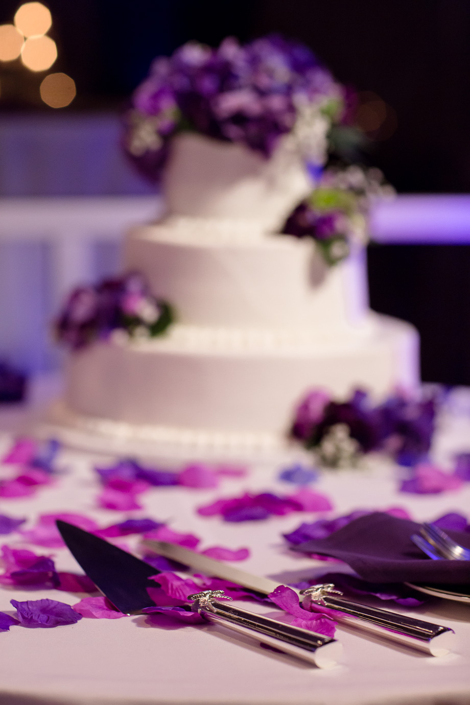 Elegant wedding cake with purple and violet petals