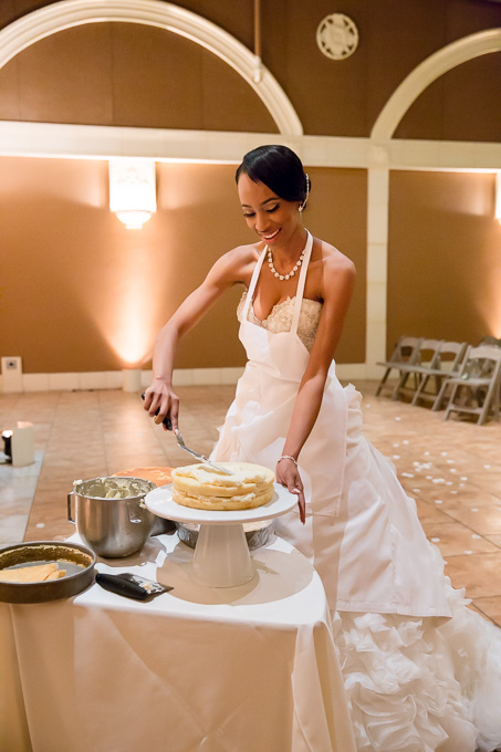 bride making her own wedding cake at the reception site in Casa Real