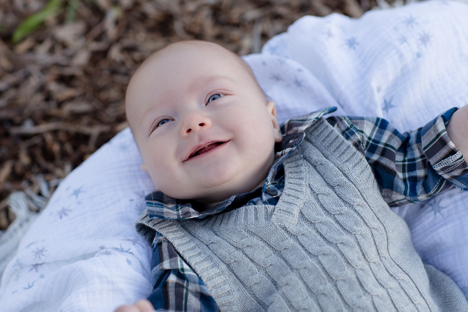 Happy 3 month old baby boy loves smiling at the camera