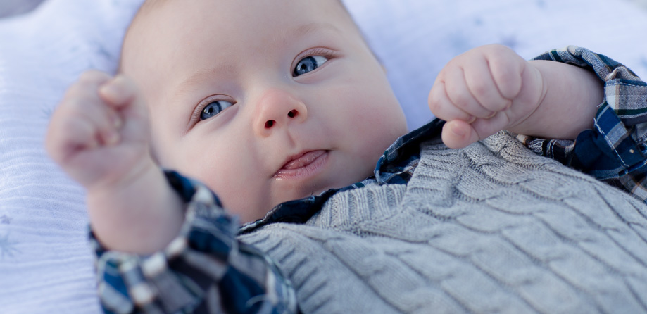 Cute 3 month old boy - big blue eyed baby boxing portrait