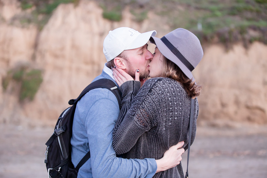 Newly engaged couple sharing a kiss after the proposal