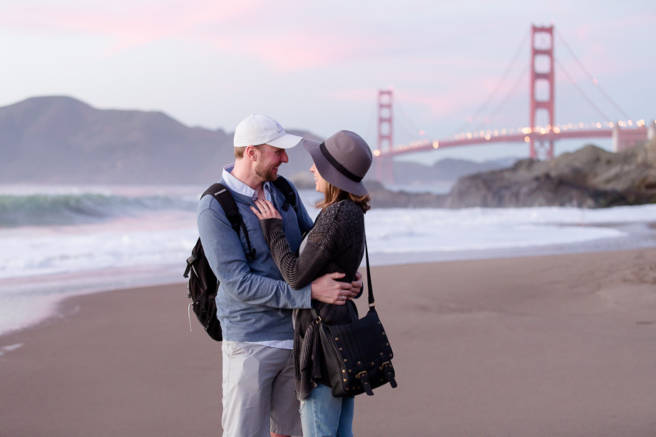 Couple sharing a moment in front of golden gate bridge after the surprise engagement