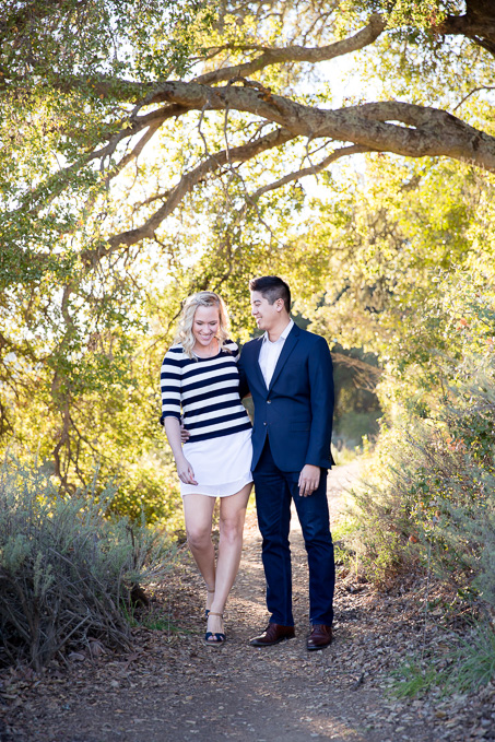 a walking shot of the engaged couple in foothills park