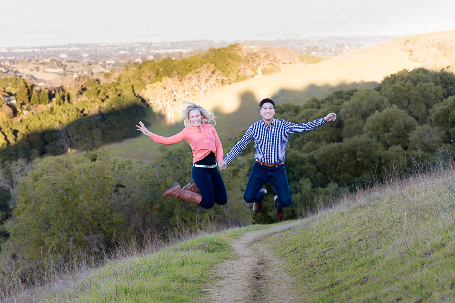 jumping on a hill - fun engagement photo