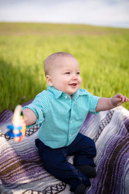 adorable 6 month old baby portrait - happy boy playing with his favorite toy