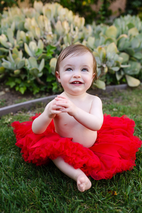 cute baby girl smiling in a red tutu