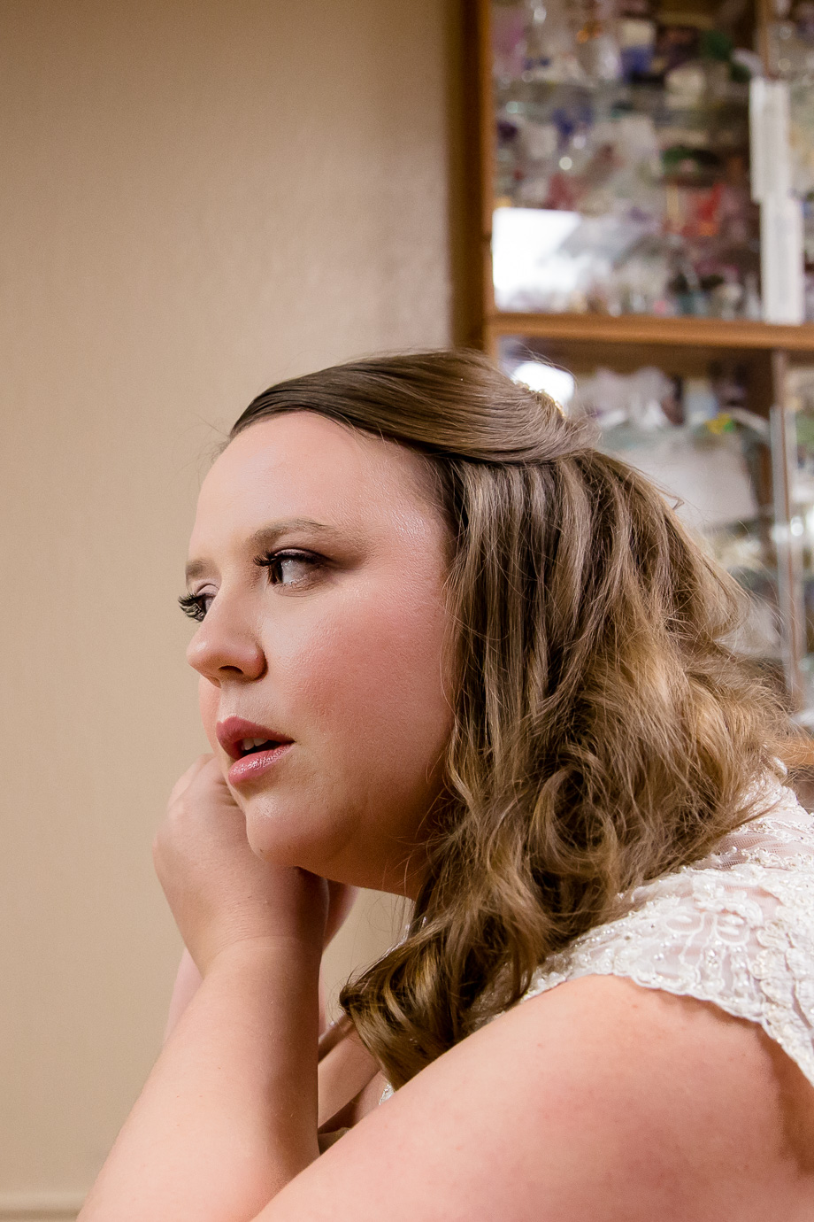 bride putting on earrings